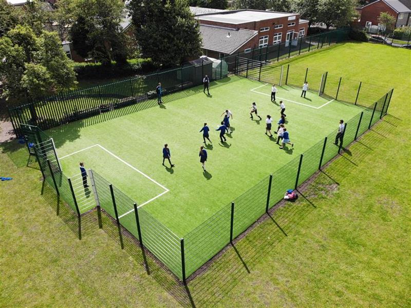 A birds eye view of the muga pitch with fencing around it