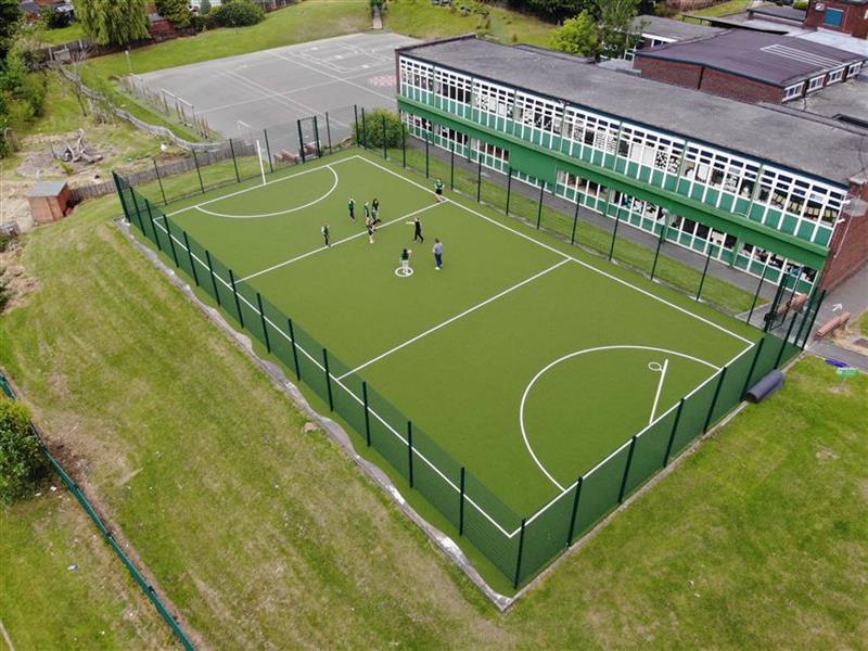 A birds eye view of children playing on the muga 