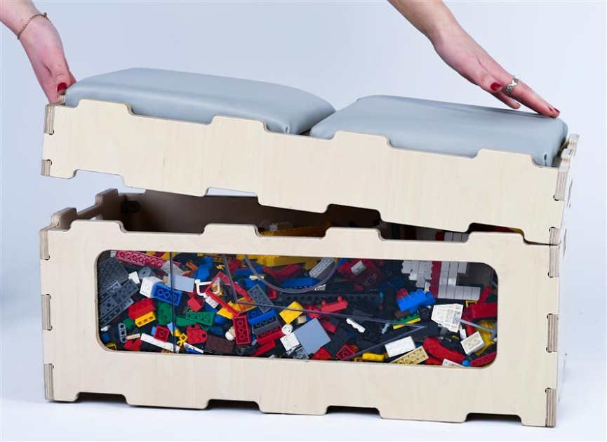 A storage box that holds lego bricks within it. They can be seen through the transparent panel on the side of the box.