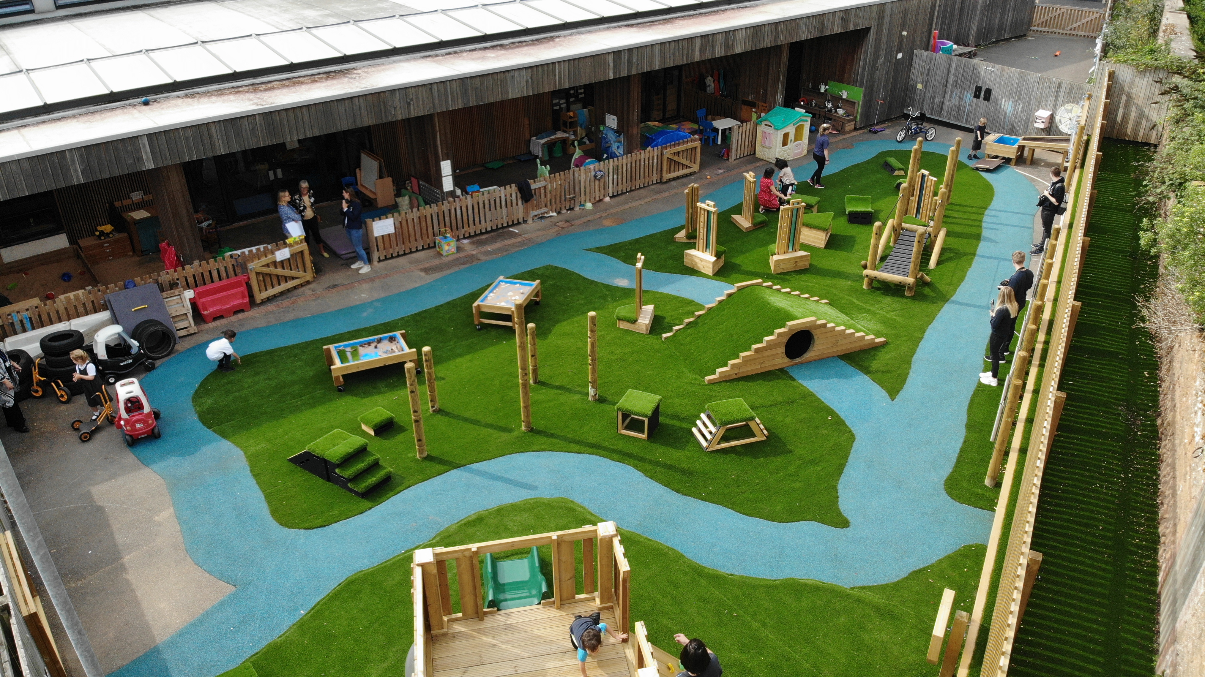 A landscape shot showcasing a variety of SEN play equipment and safety surfacing that was installed on a playground.