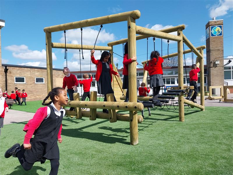 children climbing on their climbing frame in their playground setting