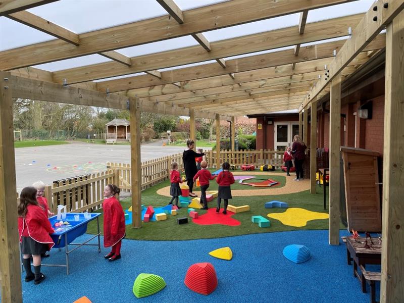 a bright and colourful canopy with children playing under the shelter
