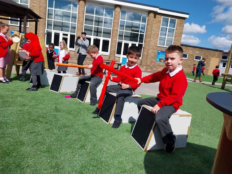 children sit on the drum seats and play a tune