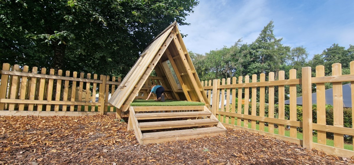 A photo of a wooden den created by Pentagon Play for a holiday park