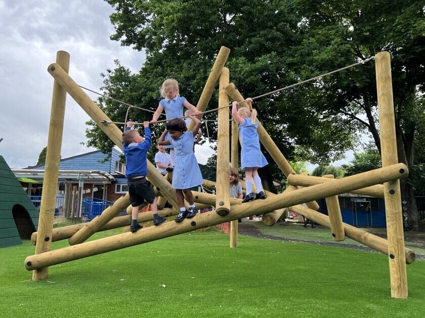 6 children playing on a Bowfell climber, created by Pentagon Play. This image shows how our climbing equipment is made of a wide variety of durable materials.