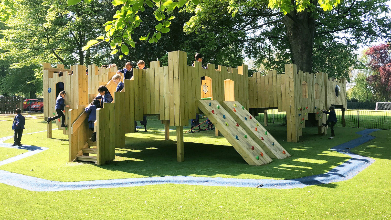 A picture of a treehouse that was installed by Pentagon Play for The Royal Wolverhampton School. It shows children engaging with the structure.