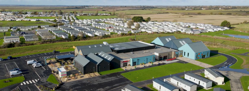 A drone photo showing the centre of the St Osyths Beach Holiday Park, highlighting the big entertainment complex they have but showing the lack of playgrounds