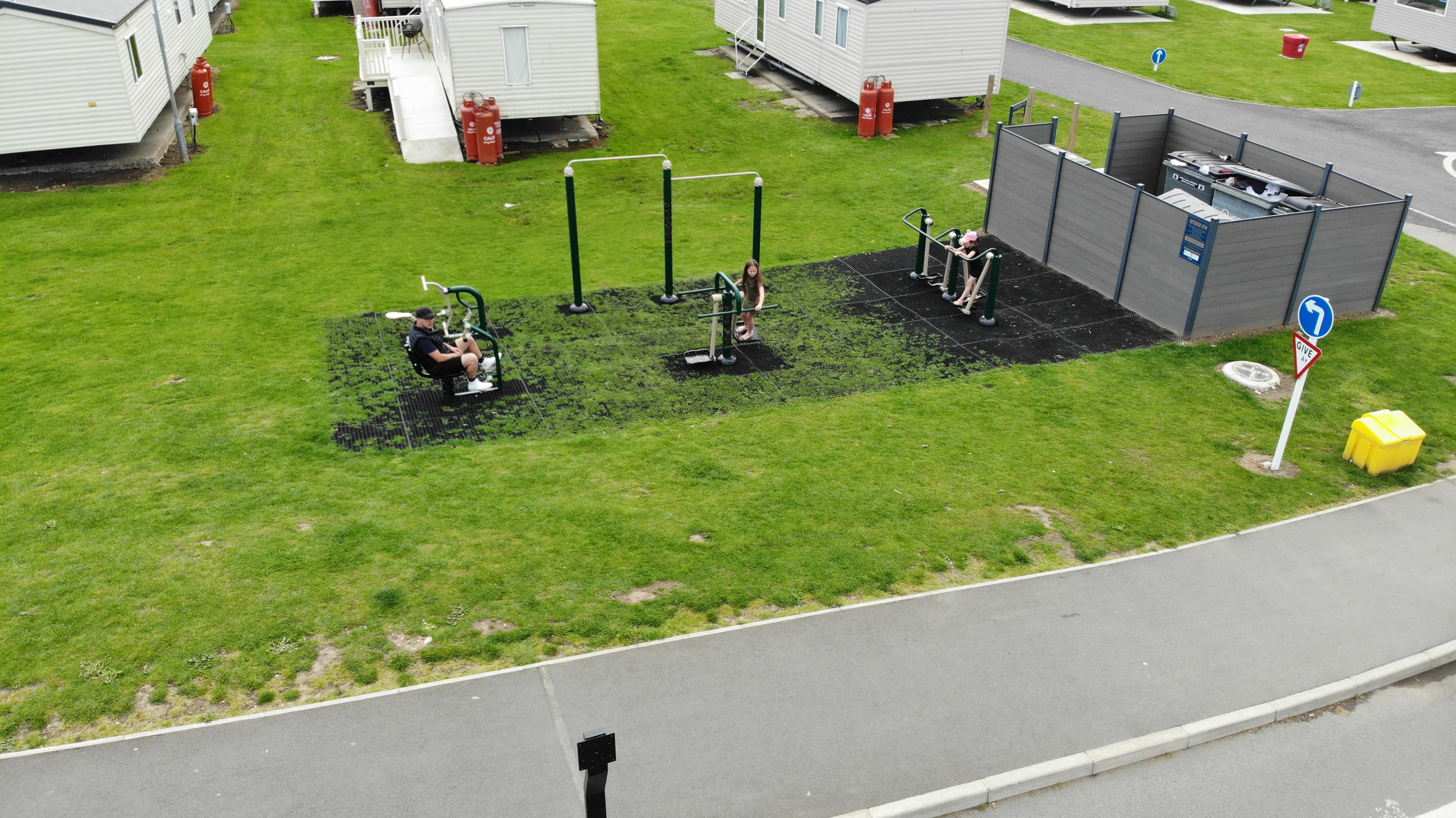 A man can be seen using the Ride and Row piece of gym equipment. Surrounding him are all the other pieces of gym equipment we supplied.