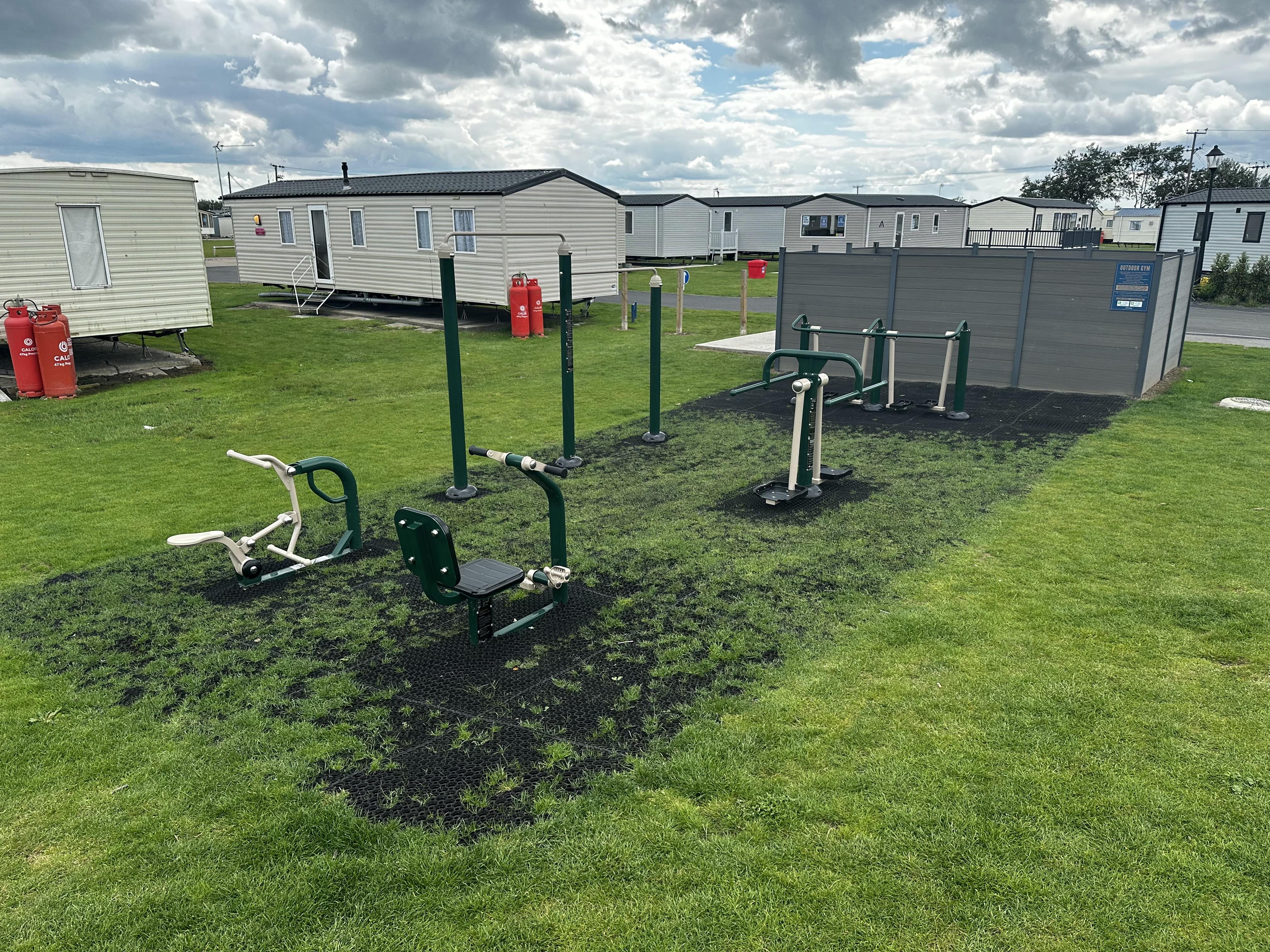 A variety of outdoor gym equipment has been installed on top of safermats, allowing the area to maintain it's natural appeal