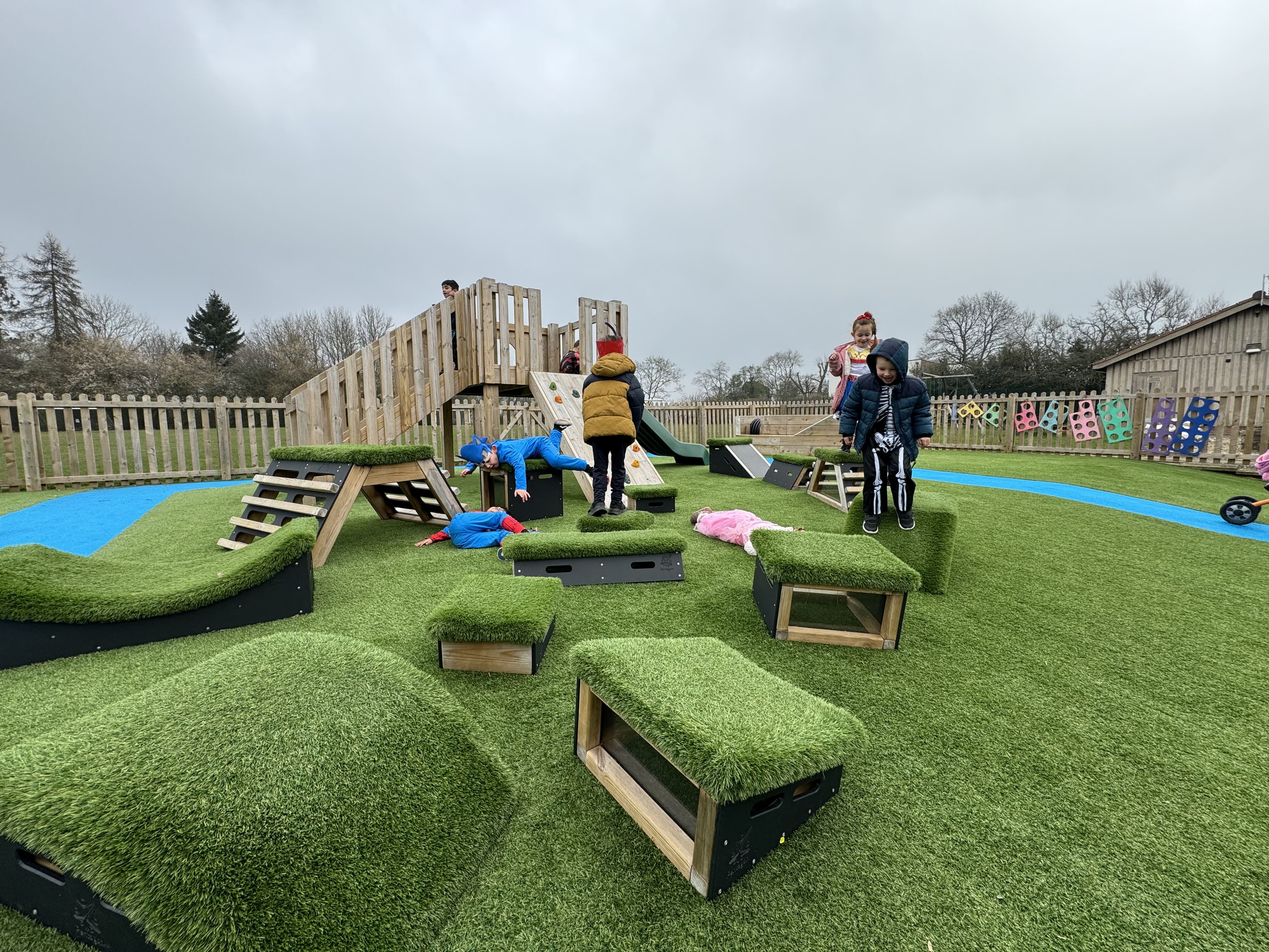 A group of children are playing on Get Set, Go! Blocks and are making their way to the play tower.