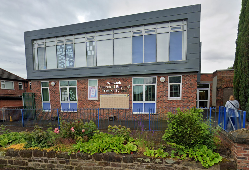 Picture of the Winwick CE Primary school from the outside. The school is a brick building, with the top half being grey.