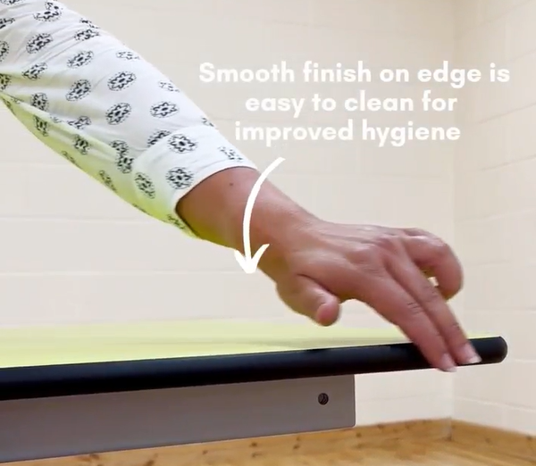 Woman is showing the smooth sides of the table, with text saying "smooth finish on edge is easy to clean for improve hygiene"