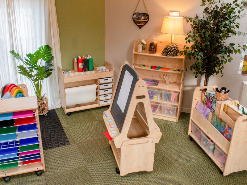 A nursery room that is full of Millhouse classroom furniture, featuring arts and crafts equipment and storage.