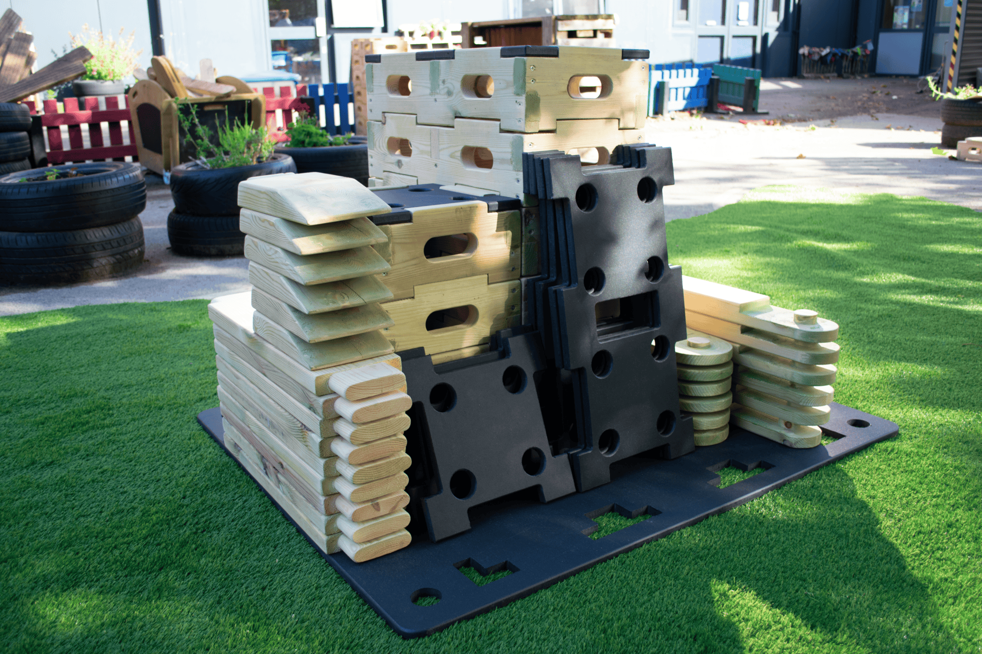 Pieces of a Play Builder set piled up on a palette, showcasing the immense size and pieces contained within this set.