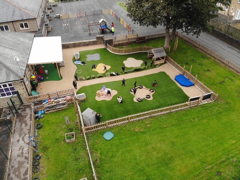 Children are playing on an EYFS playground full of unique and innovative playground equipment.