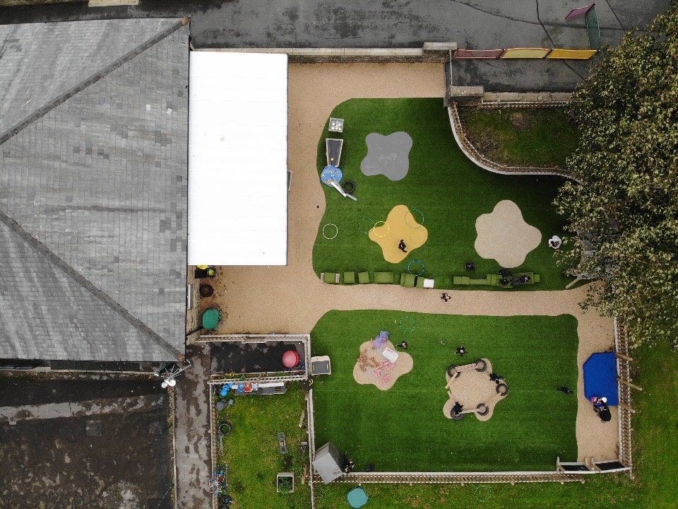 A top down view of Mount Pellon's playground, showcasing the variety of playground equipment and surfacing options incorporated on it.