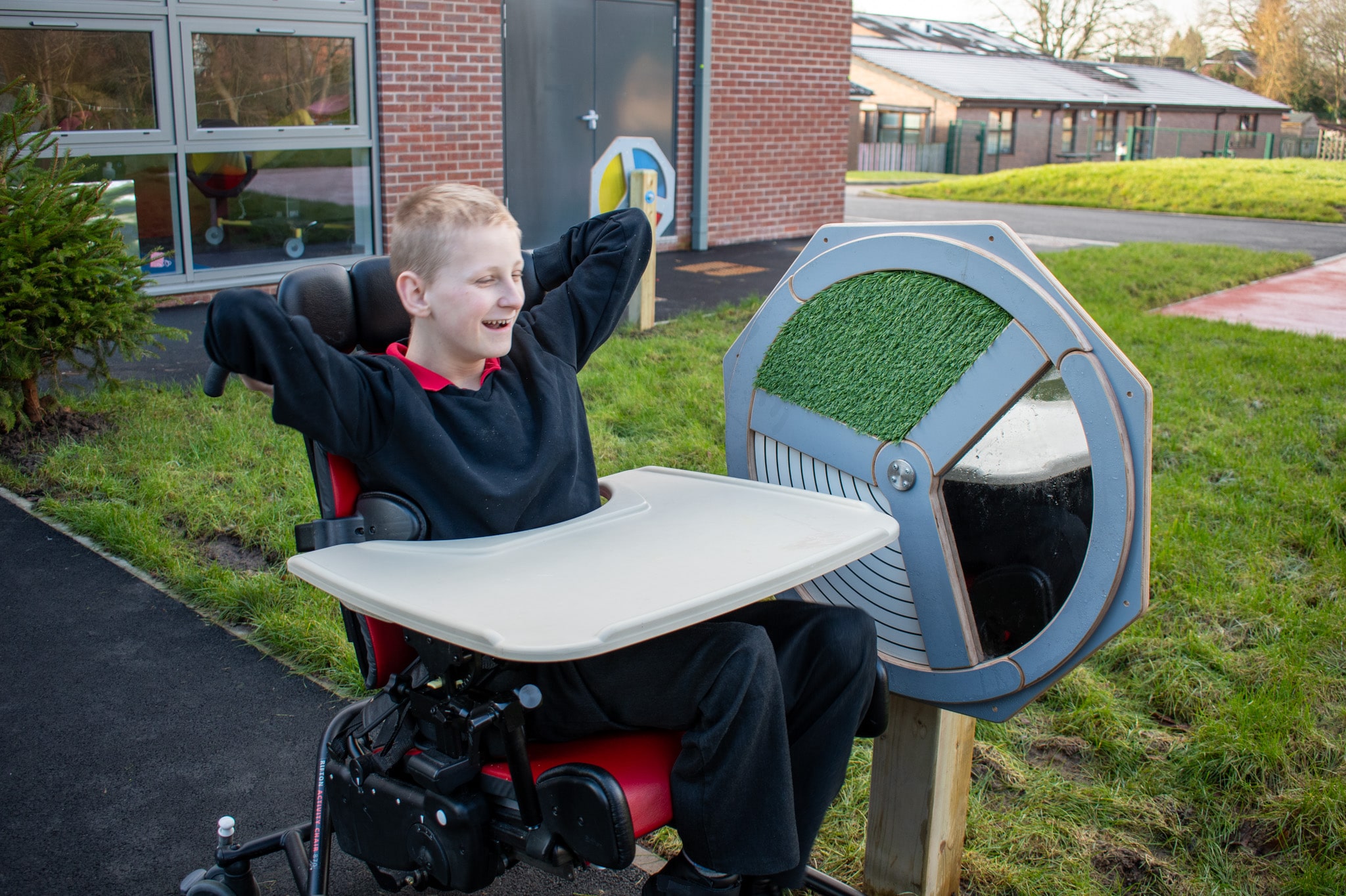 A little SEN boy is laughing as he plays with the Touch Sensory Spinner.