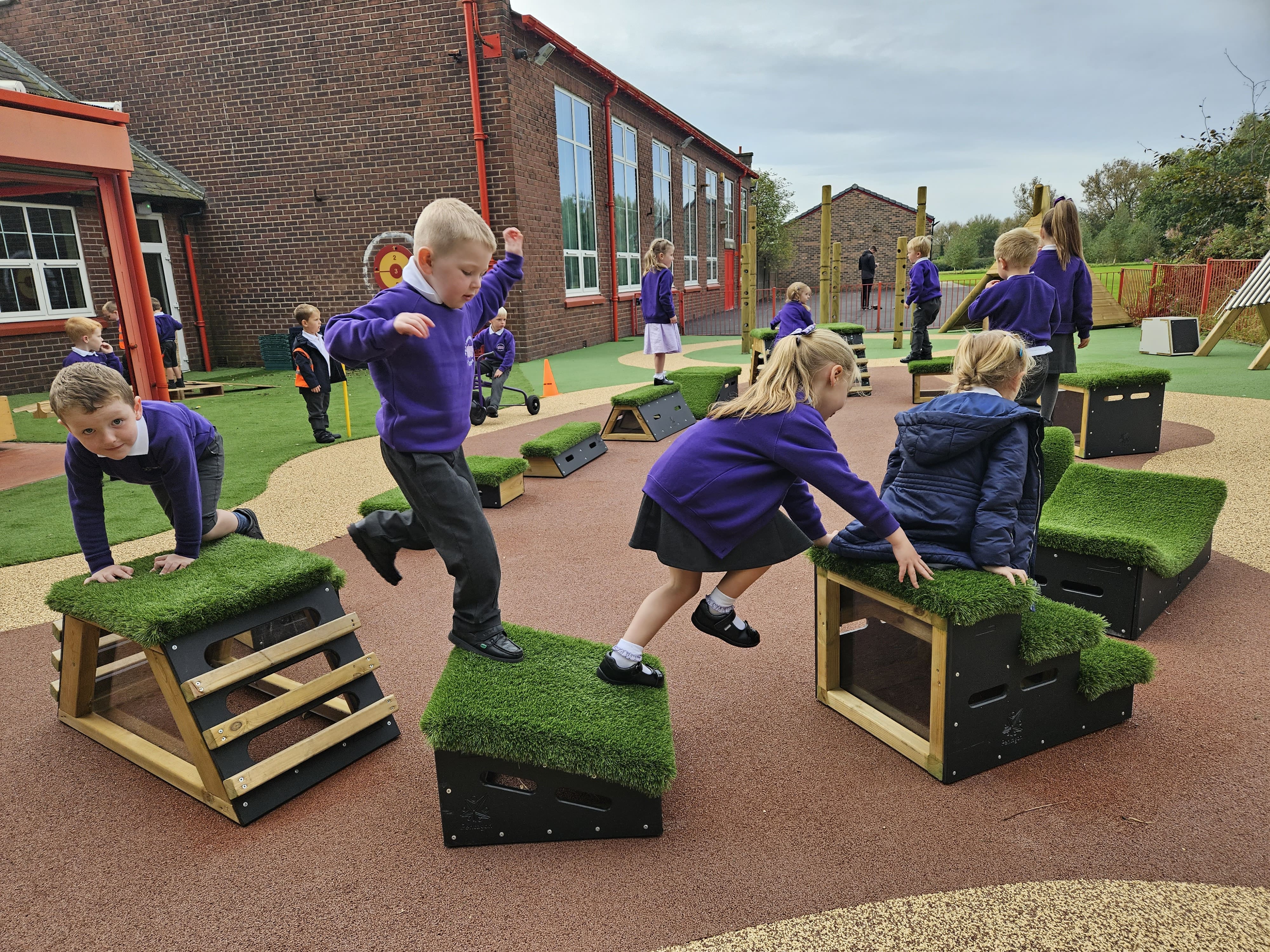 A class of EYFS children are completing an obstacle course that has been created by them by using Get Set, Go! Blocks