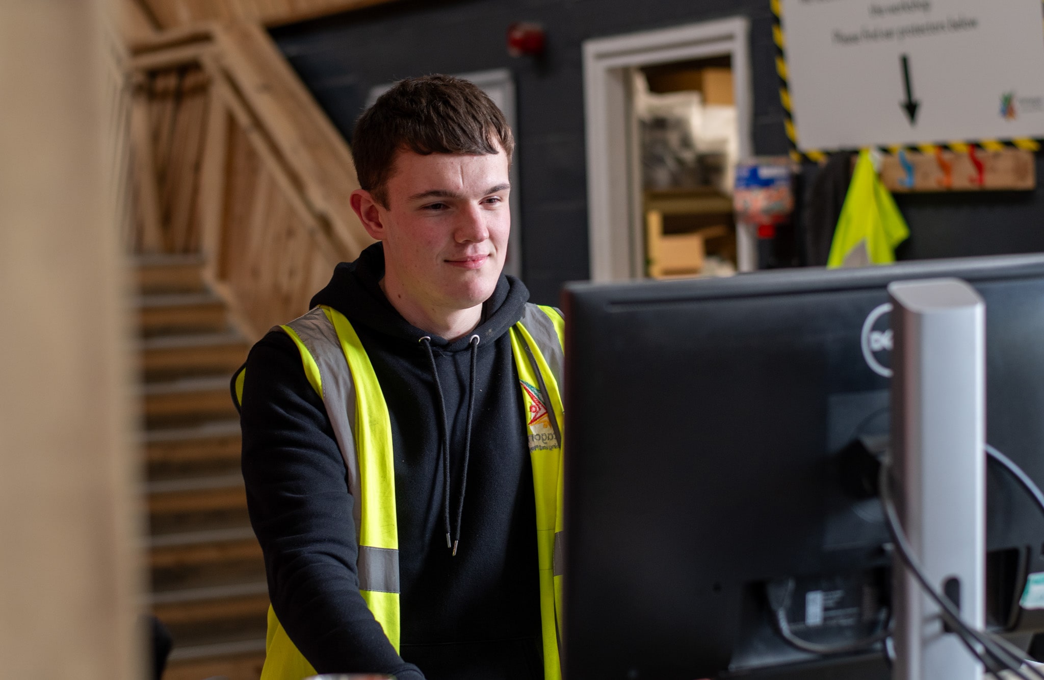 Ben Johnson is working on a computer that is in the warehouse and is sorting out the logistics.