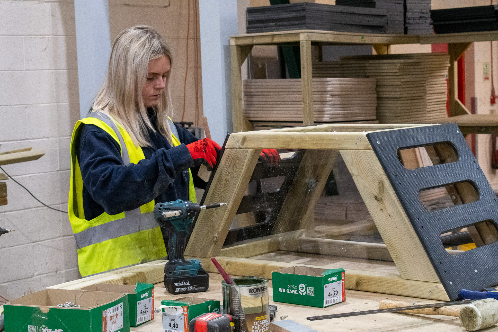 A manufacturer at Pentagon Play's warehouse is putting together a get set go block.