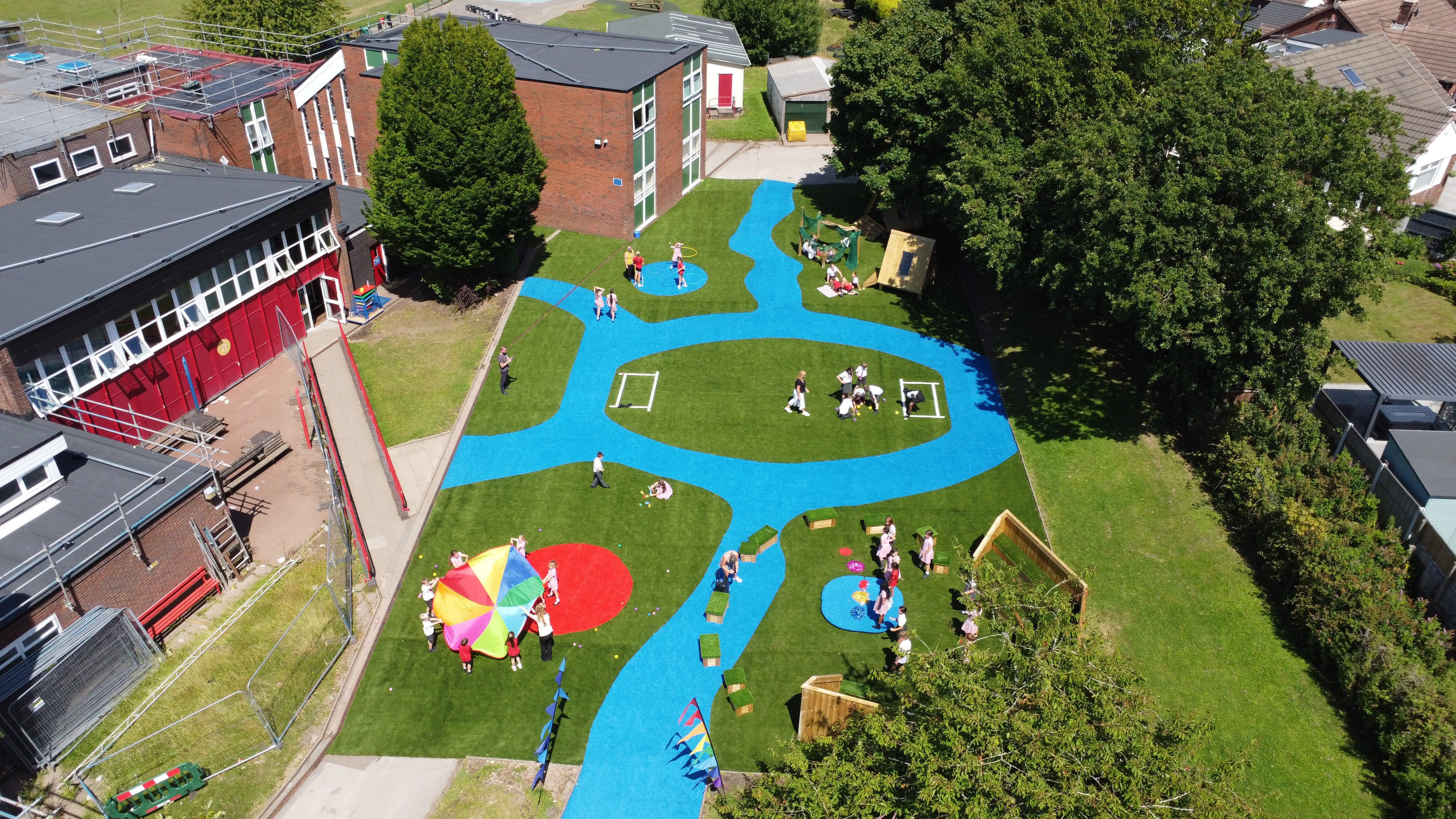 A drone shot showcasing the performance area, highlighting the amount of bespoke surfacing and play equipment.