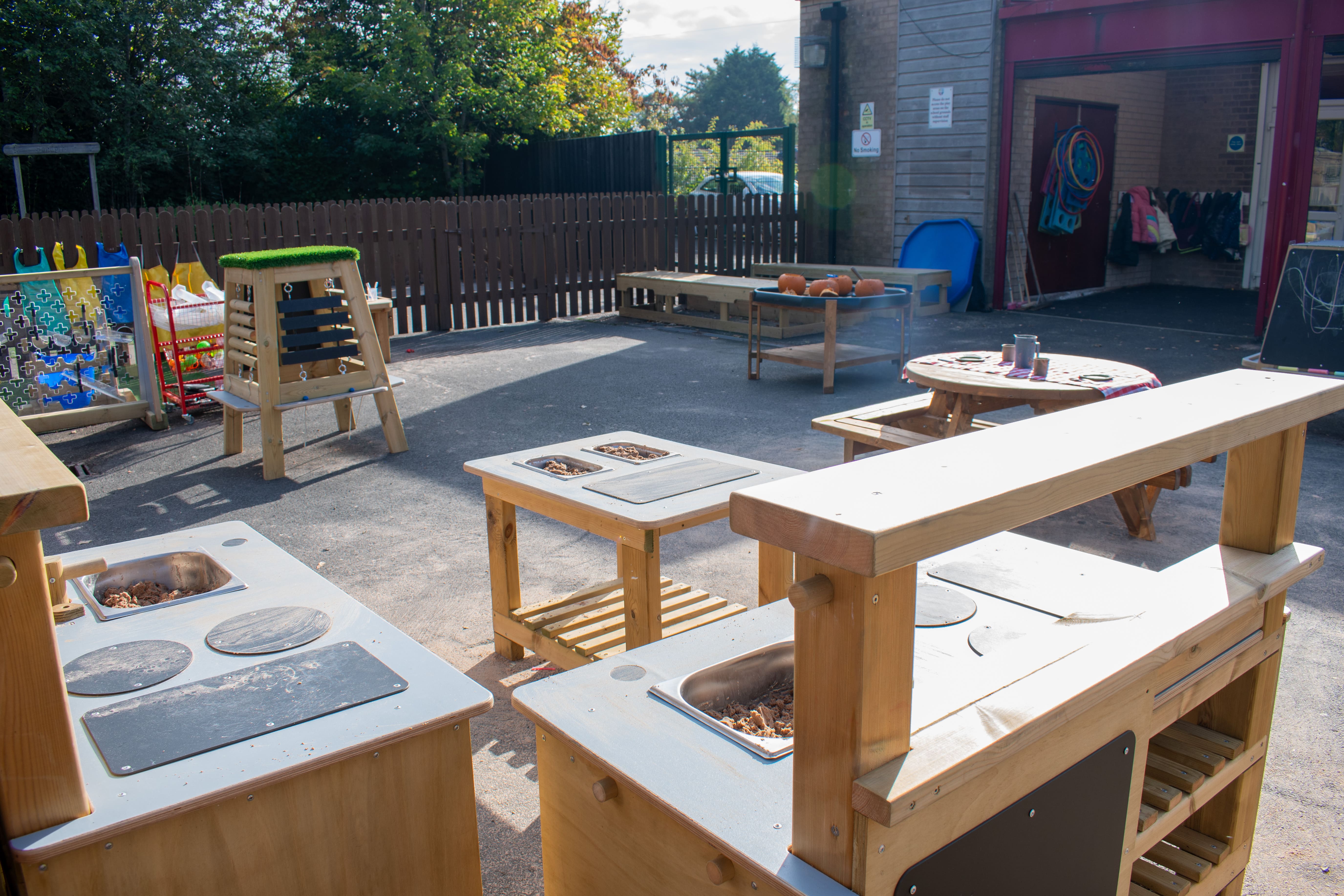 An empty playground filled with a variety of new freestanding play equipment.