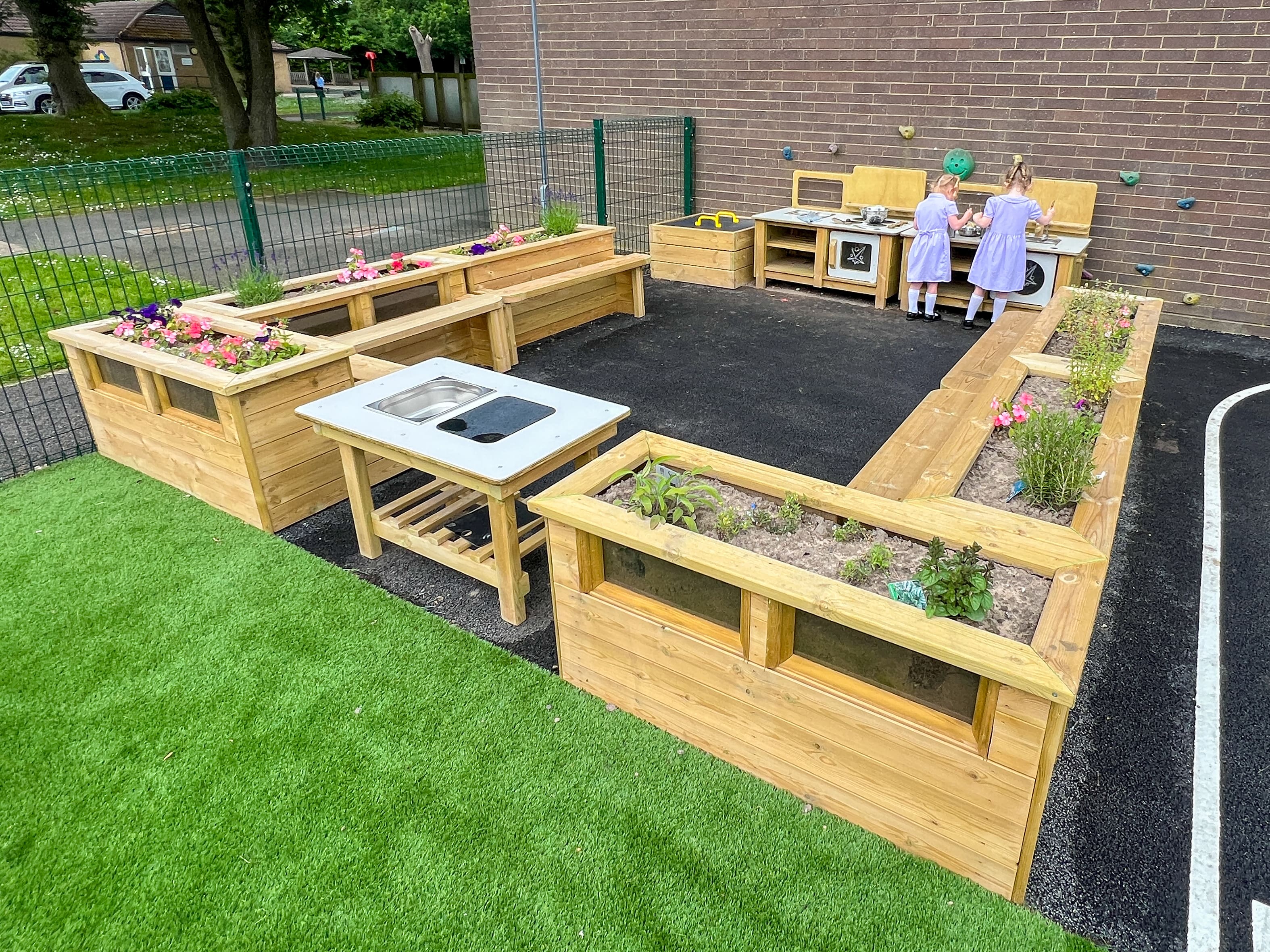 A serene and beautiful area that has a variety of nature-play related equipment and seating.