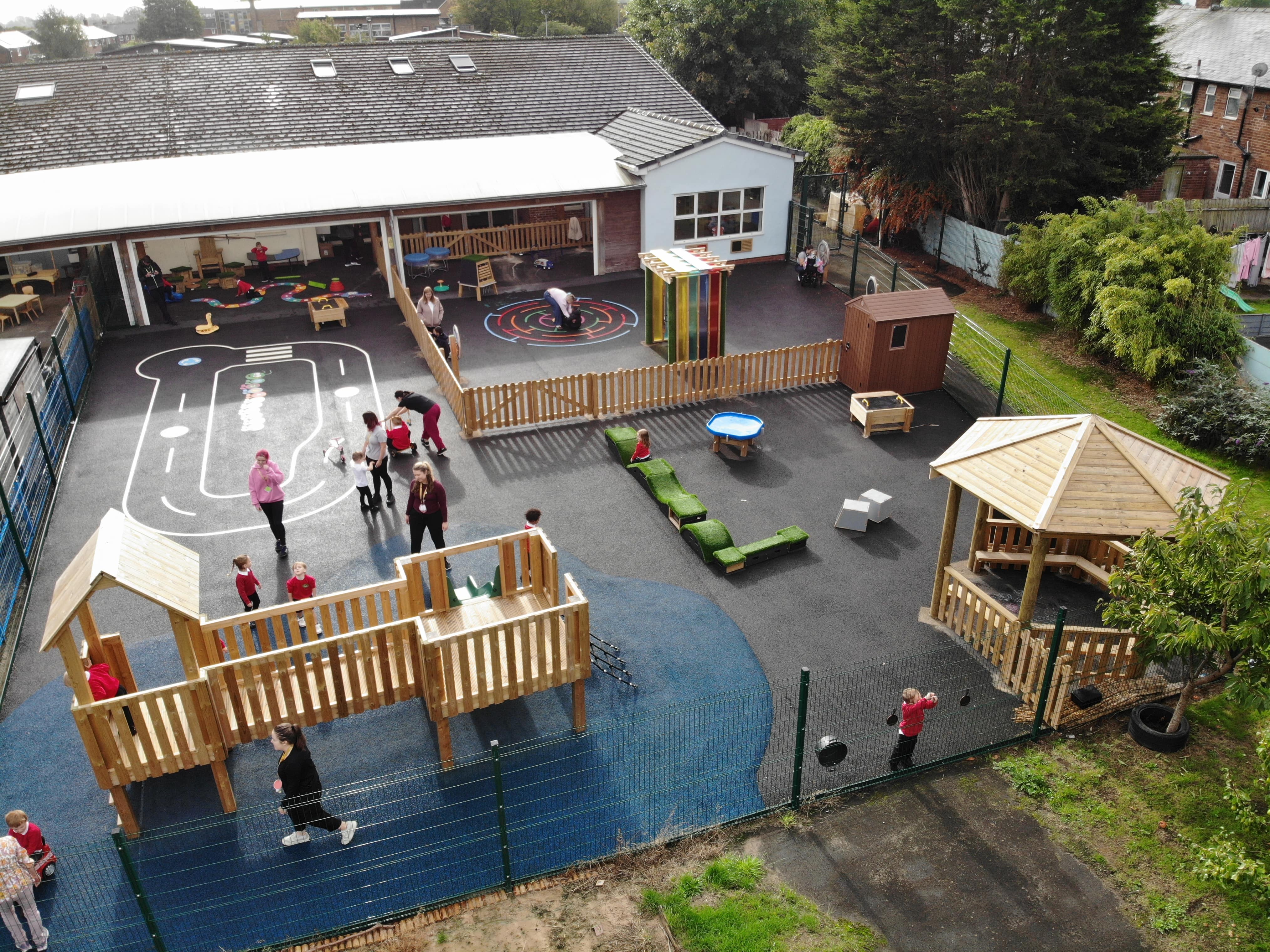 A birds-eye view of the entire new playground, showcasing the new playground surfacing and equipment.