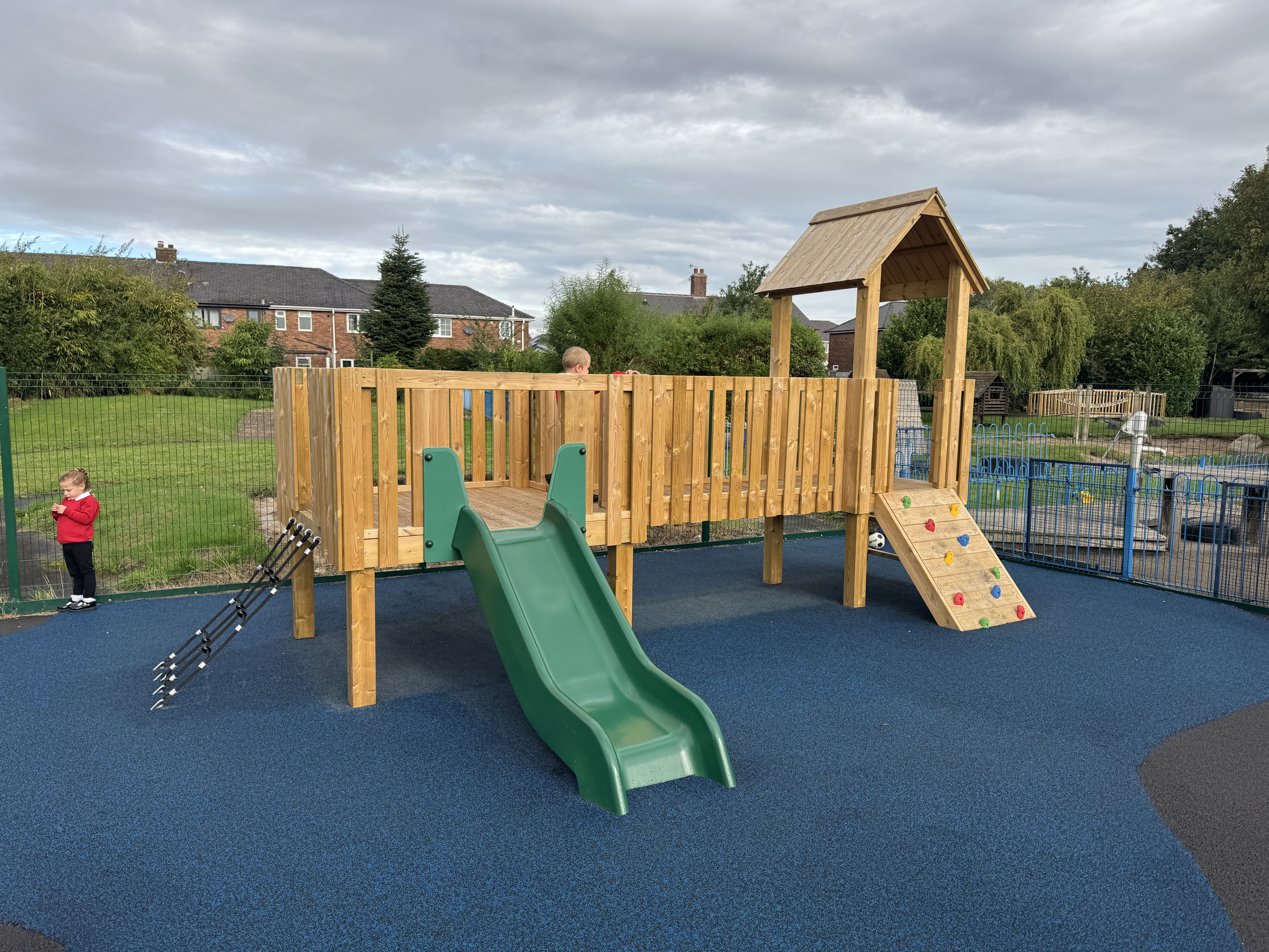 A Kenilworth Play Tower that has been installed on wetpour, as children play on it.