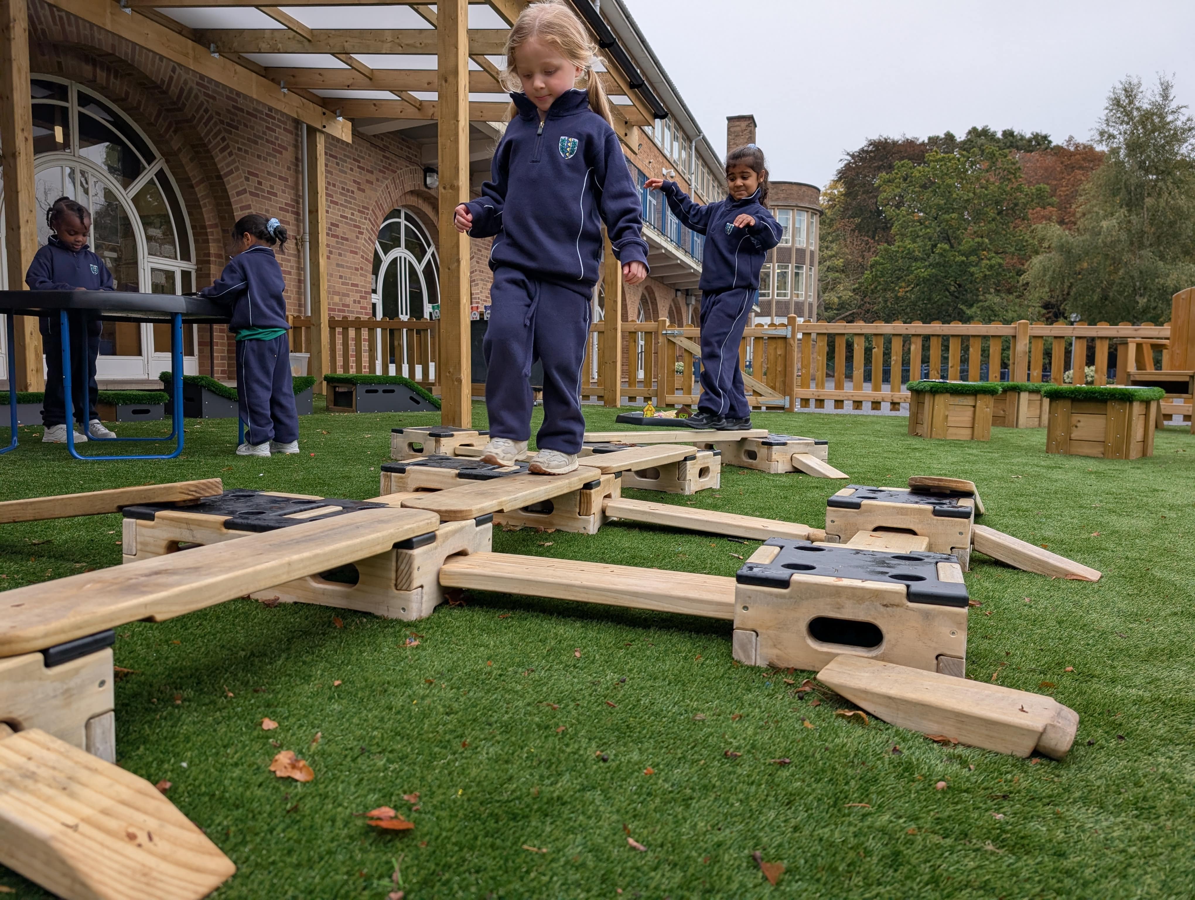 A group of children are playing on the Play Builder set!