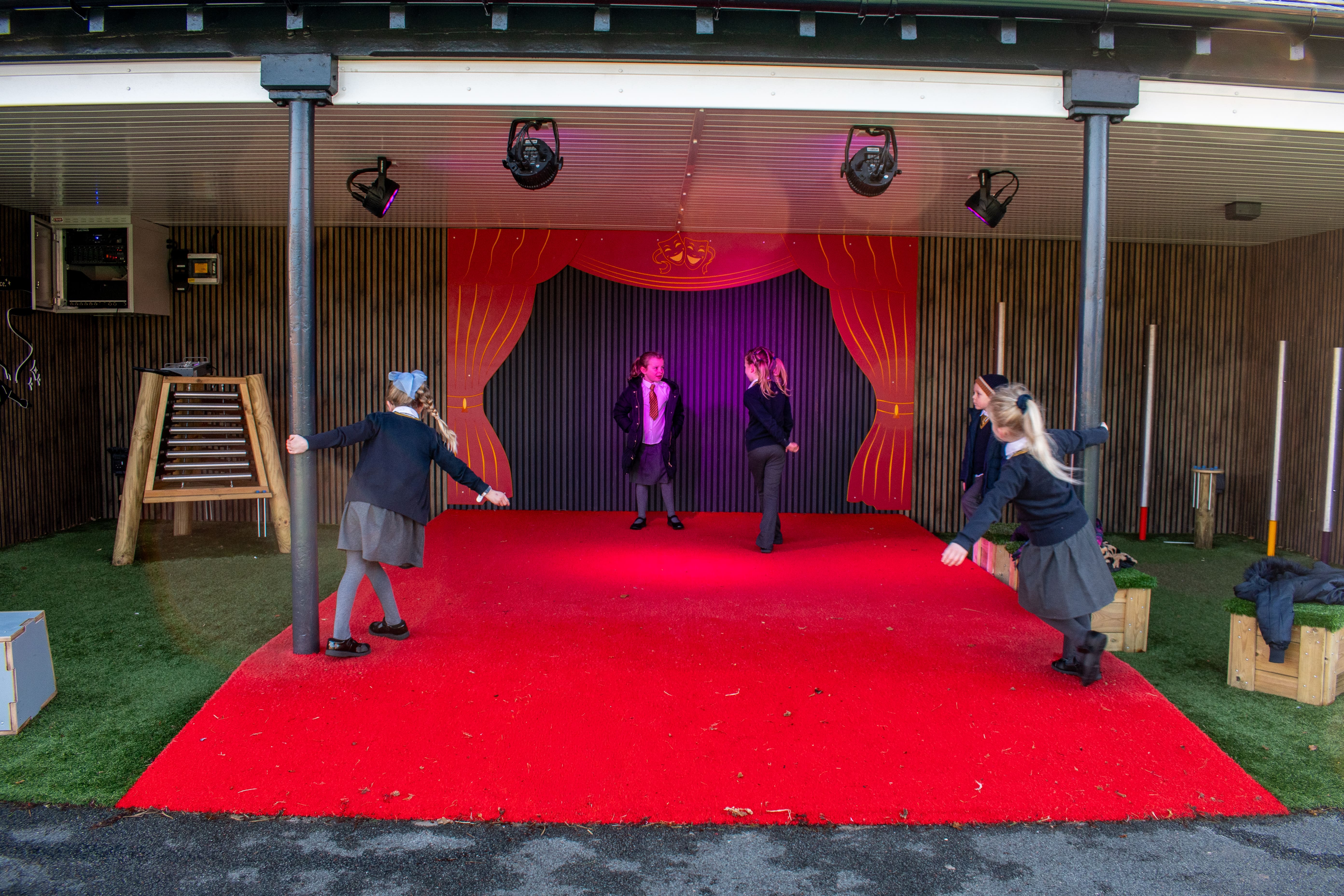 A performance stage with a group of children dancing on it.