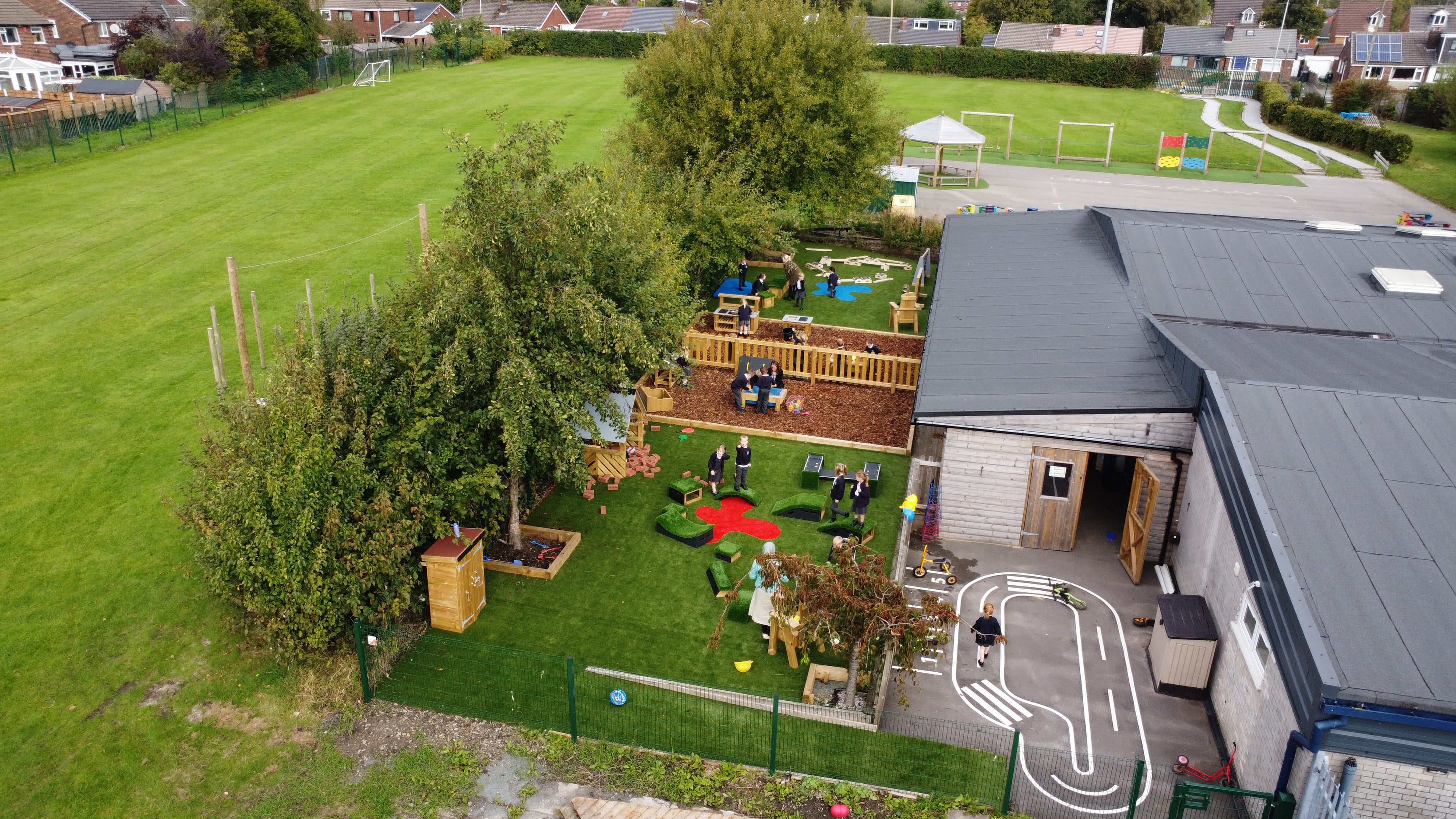 A drone shot which showcases the two new playgrounds and the new safety surfacing and play equipment installed on them.