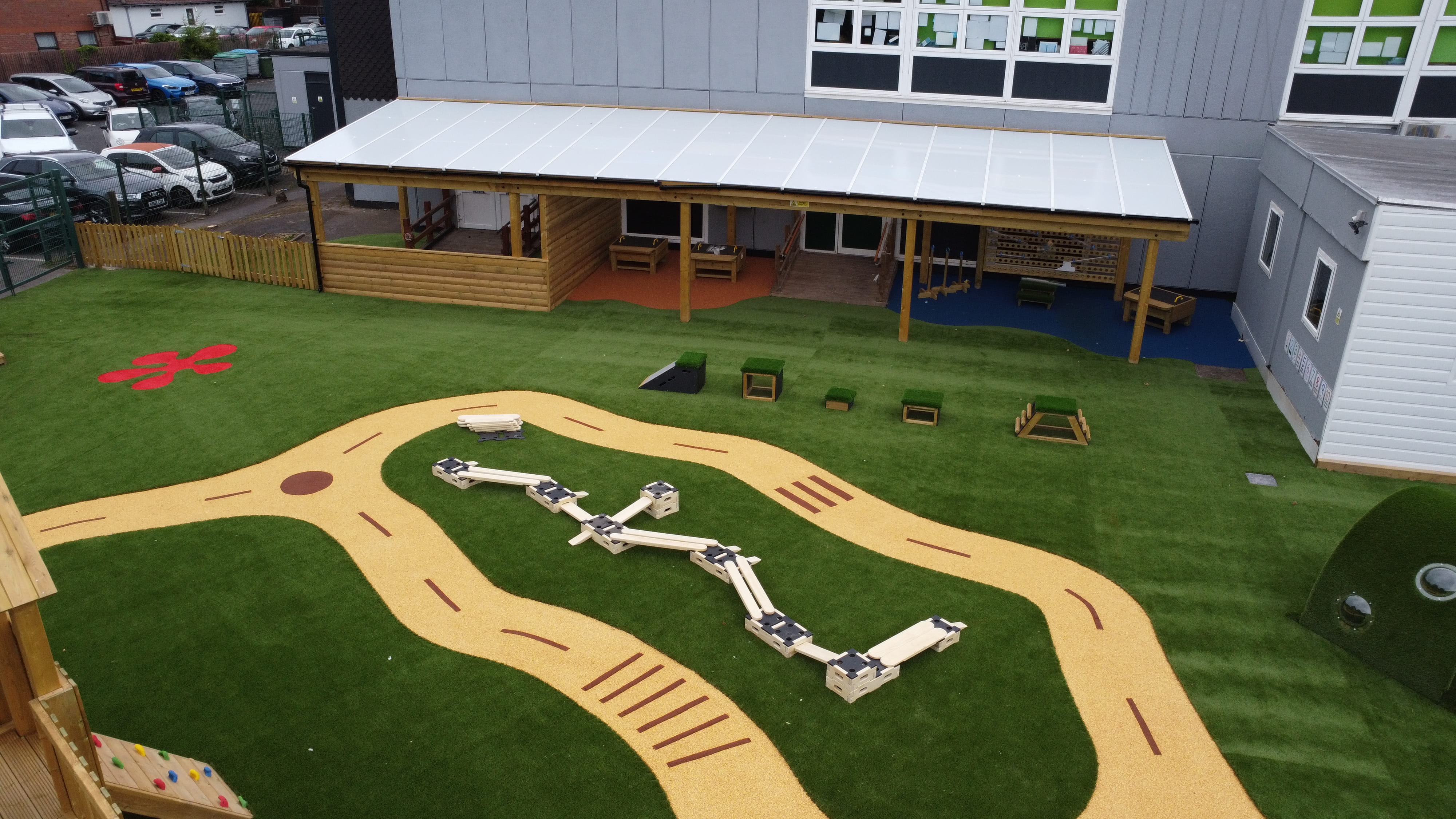 An area of the new EYFS playground at Timbertree Academy, showcasing the freestanding active play equipment and new safety surfacing.