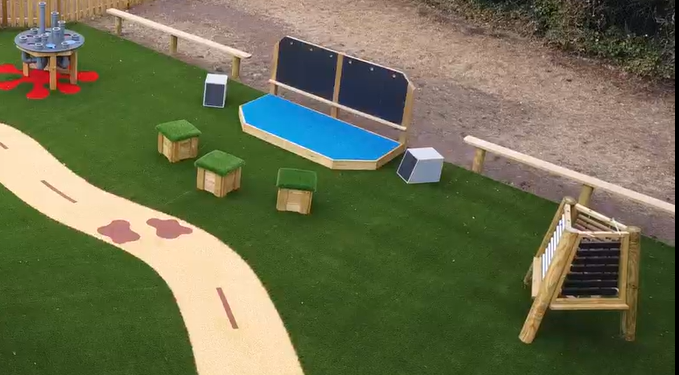 A performance stage that has some seating placed in front of it, with musical equipment placed around it.