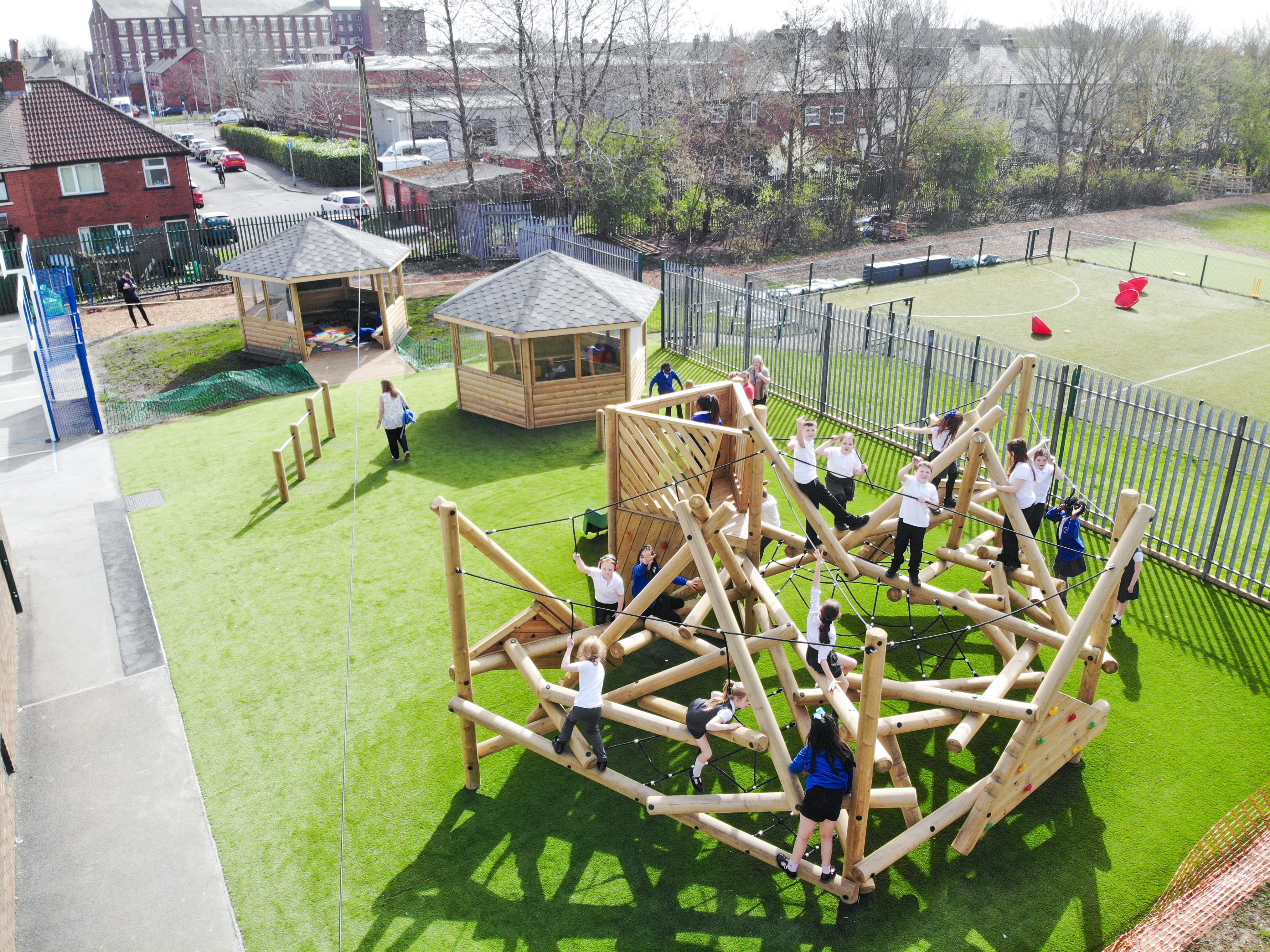 A birdseye view of the climbing frame and two outdoor classrooms, all located on artificial grass.