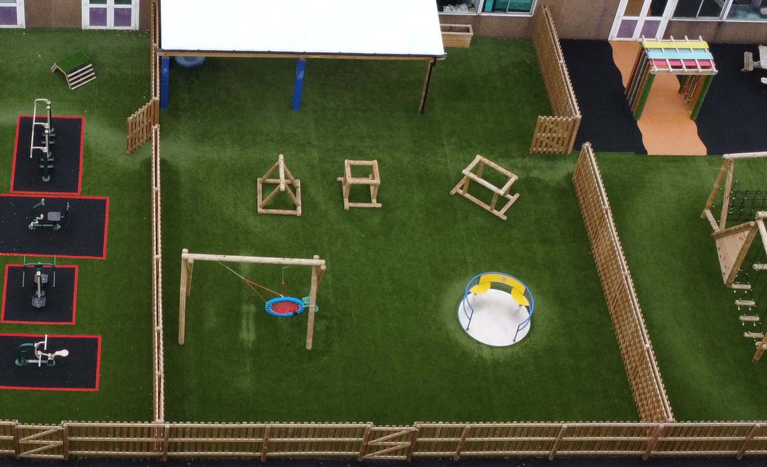 The SH/LF Class Playground, with brand new synthetic grass surfacing, featuring a variety of active play equipment.
