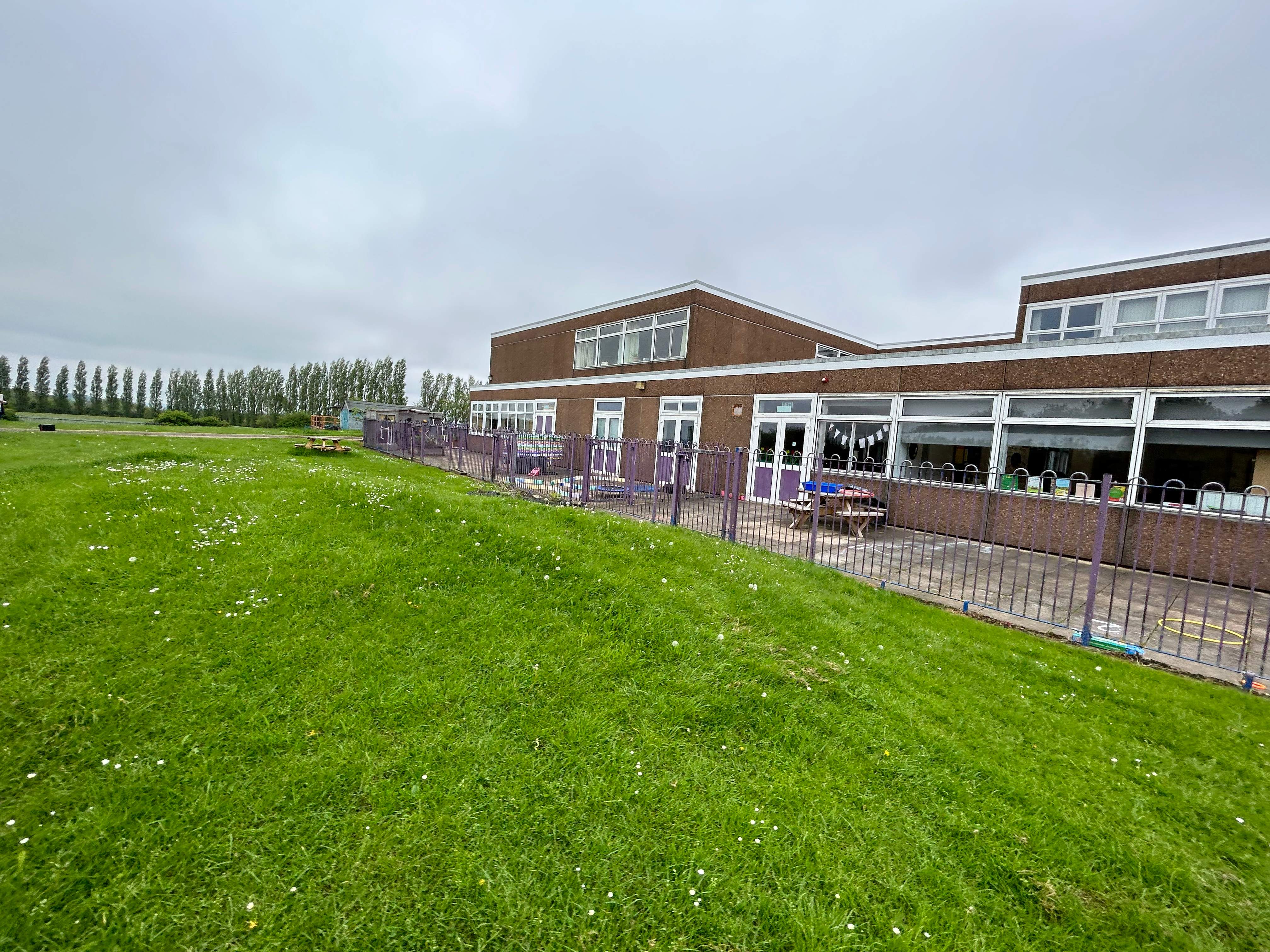 The old playground highfield school had, with natural grass surfacing and no equipment.