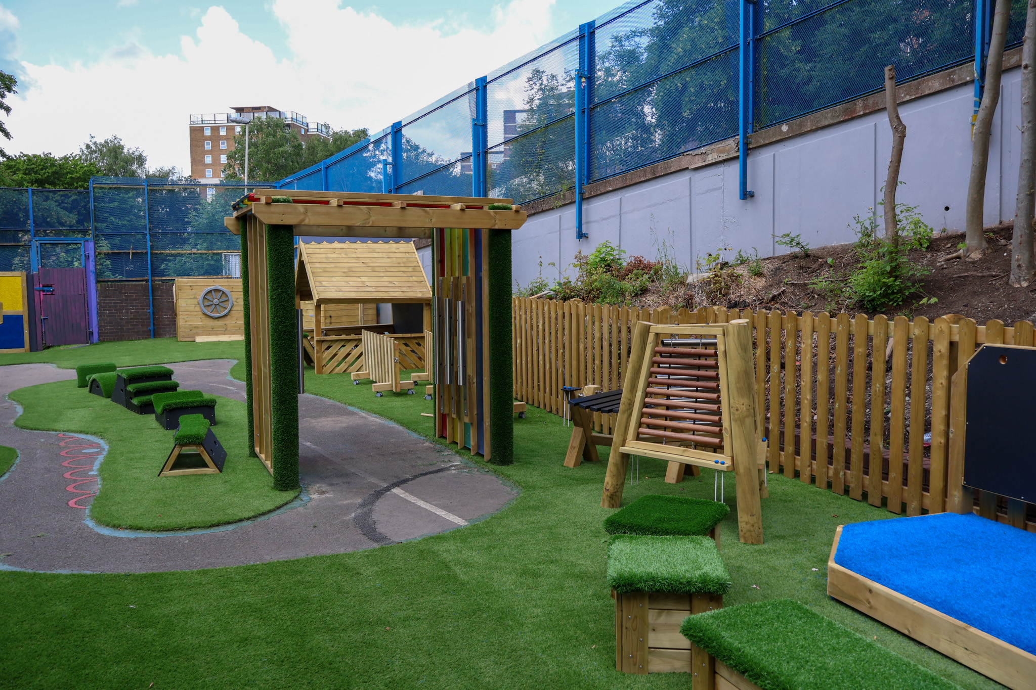 A collection of freestanding play equipment placed on artificial grass on the EYFS play area.
