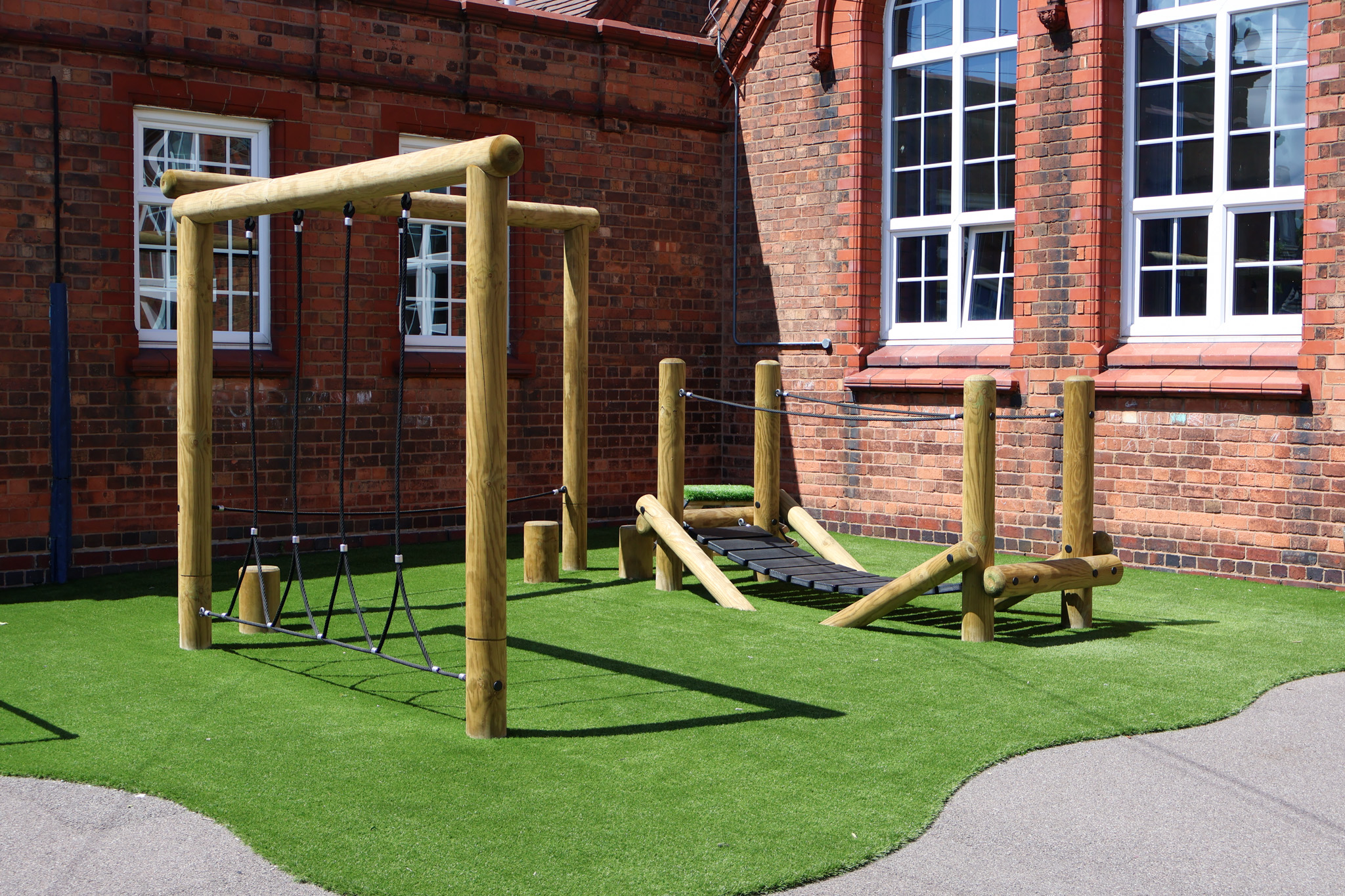 A small bespoke trim trail that has been installed on artificial grass.